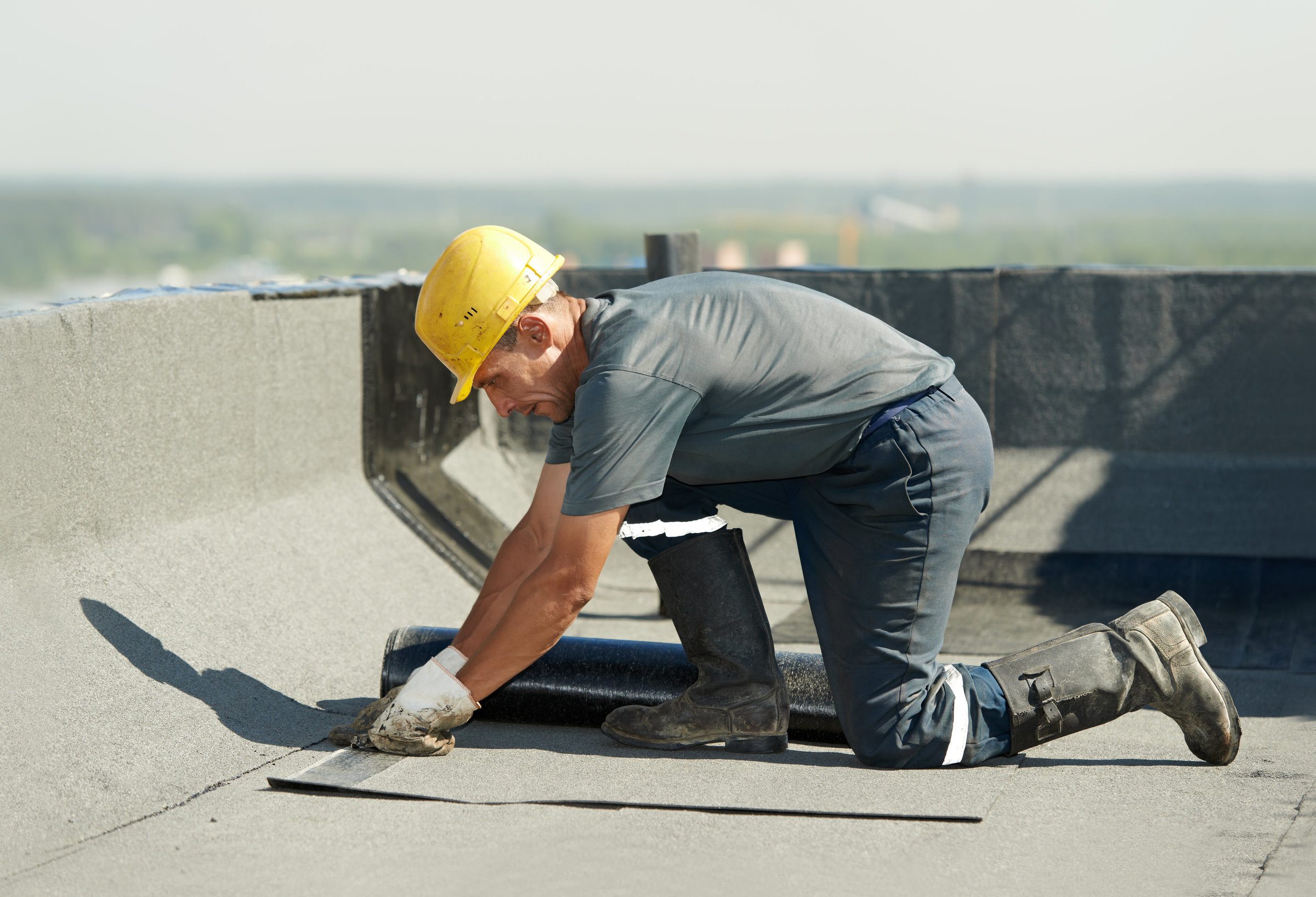 roofing contractor fixing flat roof issue