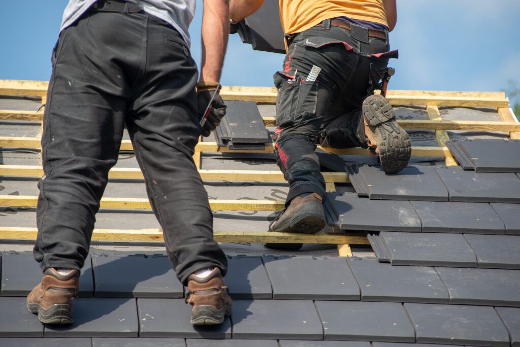 two carpenters working on the roof